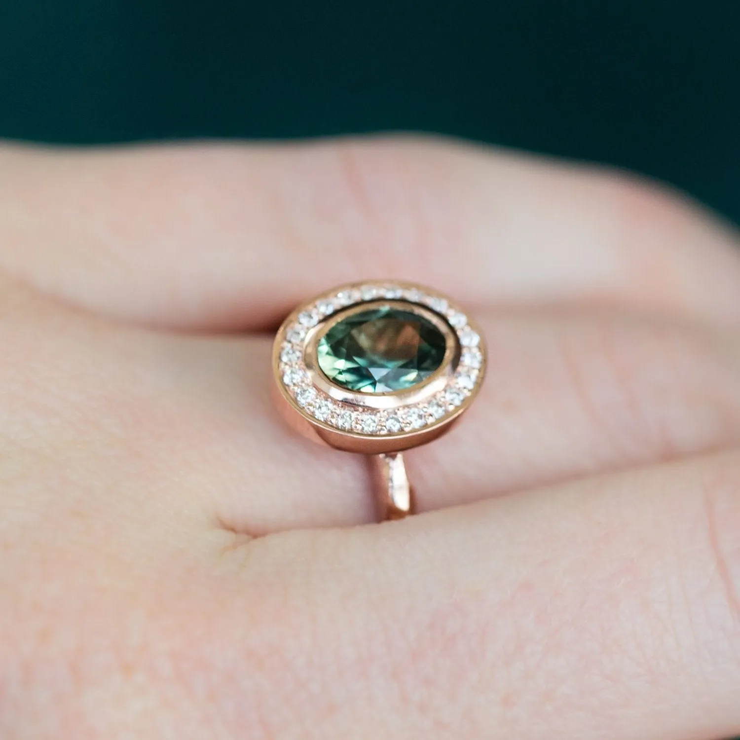 Oval Bezel Set 1.49ct Color Changing Teal Sapphire and Diamond Halo Engagement Ring - 14k Rose Gold Evergreen Band